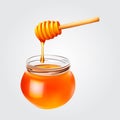 Honey droplets flowing from wooden dipper in honey jar. Royalty Free Stock Photo