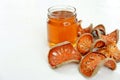 Honey and dry bael fruit on white background
