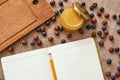 Honey, dry berries and cookbook on the table