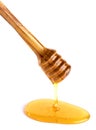 Honey flowing down from a wooden honey dipper