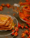The honey on baked goods. Orange calendula flower tea Royalty Free Stock Photo