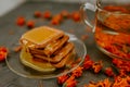 The honey on baked goods. Orange calendula flower tea Royalty Free Stock Photo