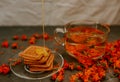 The honey on baked goods. Orange calendula flower tea Royalty Free Stock Photo