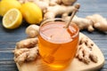 Honey and ginger on blue wooden table, closeup. Natural cold remedies Royalty Free Stock Photo