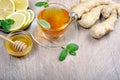 Honey, ginger, lemon and cup of tea on the wooden table. cold and flu remedy. close up. Royalty Free Stock Photo