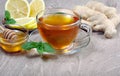 Honey, ginger, lemon and cup of tea on the wooden table. cold and flu remedy. copy spaces. Royalty Free Stock Photo