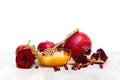 Honey in glass bowl, red apples, garnets, red rose on white wooden table on a white background with space for text Royalty Free Stock Photo