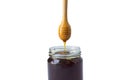 Honey in a glass jar with honey dipper on rustic wooden table background - Clipping path Royalty Free Stock Photo