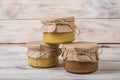 Honey in a glass jar on a light wooden background