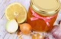 Honey in glass jar, onion, lemon and garlic, healthy nutrition and strengthening immunity Royalty Free Stock Photo