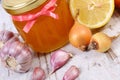 Honey in glass jar, onion, lemon and garlic, healthy nutrition and strengthening immunity Royalty Free Stock Photo