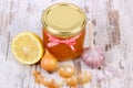 Honey in glass jar, onion, lemon and garlic, healthy nutrition and strengthening immunity Royalty Free Stock Photo