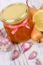 Honey in glass jar, onion, lemon and garlic, healthy nutrition and strengthening immunity Royalty Free Stock Photo