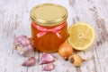 Honey in glass jar, onion, lemon and garlic, healthy nutrition and strengthening immunity Royalty Free Stock Photo