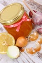 Honey in glass jar, onion, lemon and garlic, healthy nutrition and strengthening immunity Royalty Free Stock Photo