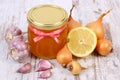 Honey in glass jar, onion, lemon and garlic, healthy nutrition and strengthening immunity Royalty Free Stock Photo