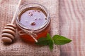 Honey in a glass jar,spoon and mint leaves on the wooden Royalty Free Stock Photo