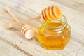 Honey in glass with wooden dipper