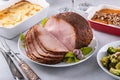 Honey glazed spiral sliced ham with side dishes for a celebration dinner Royalty Free Stock Photo