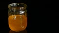 Honey jar on a black background Royalty Free Stock Photo