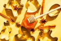 Honey jar, honey dipper and cookie cutters on yellow background Royalty Free Stock Photo