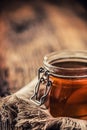 Honey jar with dipper on old woodn table Royalty Free Stock Photo