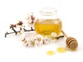 Honey in a jar, flowers and honey dipper