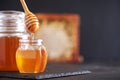 Honey jar, honeycomb and wooden spoon in jar on black background. Copy space. Autumn harvest concept Royalty Free Stock Photo