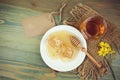 Honey jar and honeycombs over wooden rustic background.