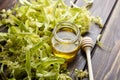 Honey in jar with linden flowers and honey dipper on wooden background Royalty Free Stock Photo