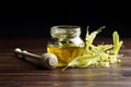 Honey in jar with linden flowers and honey dipper on wooden background Royalty Free Stock Photo