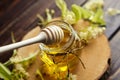 Honey in jar with linden flowers and honey dipper on wooden background Royalty Free Stock Photo