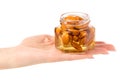 A honey jar with nuts almonds in hands Royalty Free Stock Photo