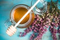 Honey jar and purple autumn heather flowers