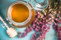 Honey jar and purple autumn heather flowers