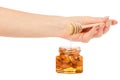 A honey jar with a spoon for honey nuts almonds in hands Royalty Free Stock Photo