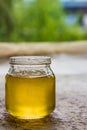 Honey in jar and window with green on backcground Royalty Free Stock Photo