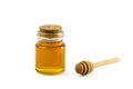 Honey in jar and wooden honey dipper isolated on white background with clipping path. Royalty Free Stock Photo