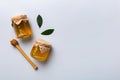 Honey jar with wooden honey dipper on white background top view with copy space. Delicious honey bottle Royalty Free Stock Photo