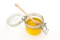 Honey jar with a wooden stick for honey on white background. Concept of healthy food. Honey like superfood. Minimalism style