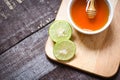 Honey lemon lime on cutting board with honey cup on dark wooden background Royalty Free Stock Photo