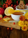 Honey, lemon, rowan berries and thermometer. Concept of treating seasonal cold Royalty Free Stock Photo