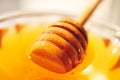 Honey macro with wooden honey dipper in the glass jar Royalty Free Stock Photo