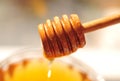 Honey macro with wooden honey dipper and glass jar