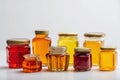 Honey packaging displayed in groups with various shapes and sizes on a white surface Generative AI Royalty Free Stock Photo