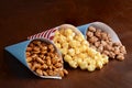 Honey peanuts with caramel popcorn and honey sesame seed almonds in paper cones