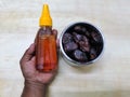 Honey in the Plastic Bottle and Arabian dates on white background