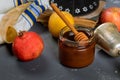 Honey on the pomegranate and apples. Jewishs new year Rosh Ha Shana torah book, kippah yamolka and shofar Royalty Free Stock Photo