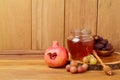 Honey, pomegranate and grapes over wooden background. Jewish New Year Rosh hashana