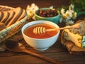 Honey pot and dipper at rustic table with bread, raisins, chamomile and Honey comb Royalty Free Stock Photo